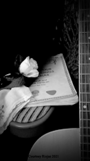 A beautiful picture of a guitar and a music book.